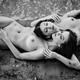 Two nude young women lying on sea shore sand together. Beautiful nude... (thumbnail)