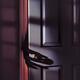 Spooky male hand in a glove reaching for a door handle from behind a d... (thumbnail)