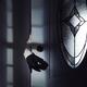 Man hand in a black gloves reaching for a door handle from behind a do... (thumbnail)