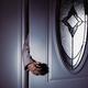 Woman's hand reaching for a door handle from behind a dark shadow... (thumbnail)