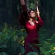 Woman in red dress beating shamanic drum in tranquil dark forest natur... (thumbnail)