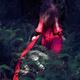 Woman walking into a deep dark shadowy forest in long red dress flowin... (thumbnail)