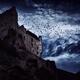Flock of black crows flying over a French stone castle on a mountain c... (thumbnail)