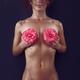 Beautiful naked woman with pink camellia flowers in her hands covering... (thumbnail)