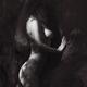 Woman standing naked leaning against a tree in a dark shadowy forest w... (thumbnail)