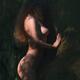 Woman standing naked leaning against a tree in a dark shadowy forest w... (thumbnail)