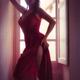 Woman in sexy elegant red dress standing by a bright French window in... (thumbnail)