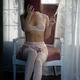 Sexy woman in pink lingerie and stockings sitting in an antique chair... (thumbnail)