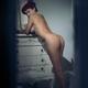 Sexy French woman in beret standing naked leaning against an antique p... (thumbnail)