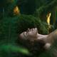Face of a woman lying on green moss forest bathing, Shinrin-Yoku conce... (thumbnail)