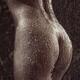 Artistic nude closeup of sexy naked woman body, wet shiny back and but... (thumbnail)