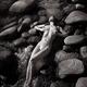 Sexy nude woman lying on rocks in water with her sensual wet naked bod... (thumbnail)