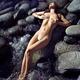 Sexy nude woman lying on rocks in water with her sensual wet naked bod... (thumbnail)