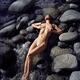 Beautiful nude woman lying like a goddess on rocks in water with her s... (thumbnail)