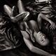 Beautiful sexy woman lying on silky bed in ecstatic pose with large Ku... (thumbnail)