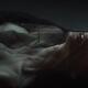 Expressive sensual closeup of a nude woman covered with a sheer black... (thumbnail)
