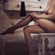 Sexy French woman sitting naked dressing up by a wardrobe putting on s... (thumbnail)