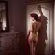 Sexy French woman in beret standing naked leaning against an antique w... (thumbnail)