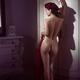 Sexy French woman posing nude leaning against an antique wardrobe reve... (thumbnail)