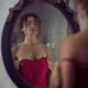 Sexy woman in red silky nightgown by the mirror with male hands undres... (thumbnail)
