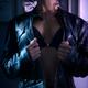 Young woman opening up unzipped leather jacket revealing her sexy blac... (thumbnail)