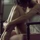 Sensual emotional portrait of young woman in night shirt sitting in ar... (thumbnail)