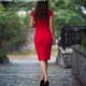 Elegant woman in red dress with umbrella walking away in the rain on w... (thumbnail)
