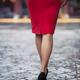 Rear view of a sexy woman in red dress and high heel shoes walking on... (thumbnail)