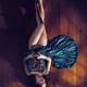 Sensual art nude portrait of woman in green dress with bare legs lying... (thumbnail)