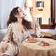 Beautiful woman in vintage Venetian carnival dress eating pasta with s... (thumbnail)