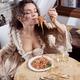 Beautiful sensual woman in vintage Venetian carnival dress eating past... (thumbnail)
