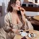 Beautiful Italian woman in vintage carnival dress eating pastries and... (thumbnail)