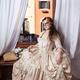 Beautiful young lady in vintage Italian dress and carnival mask sittin... (thumbnail)
