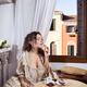 Beautiful elegant lady in Venetian carnival dress eating pastries and... (thumbnail)