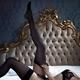 Woman in sexy black lace underwear lying on antique bed putting on sto... (thumbnail)