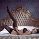 Beautiful sexy woman in black lingerie putting on stockings on her leg... (thumbnail)