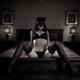 Sexy girl in cat mask black lingerie and stockings reclining on antiqu... (thumbnail)