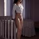 Beautiful young woman standing half-naked wearing only a top revealing... (thumbnail)