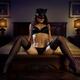 Sexy cat woman in a black kitty mask sitting on a bed in a provocative... (thumbnail)