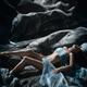 Beautiful woman lying on smooth river rocks with her barely covered se... (thumbnail)