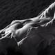 Art nude back and white, half-naked woman lying in sea water her naked... (thumbnail)