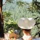 Romantic young woman in sun hat and underwear having a picnic in sunny... (thumbnail)