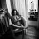 Beautiful nude woman with expressive seductive look sitting naked in c... (thumbnail)