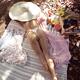 Young woman in sun hat and underwear relaxing topless at a picnic in s... (thumbnail)