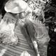 Woman in sun hat and underwear relaxing topless at summer picnic view... (thumbnail)