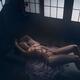 Sensual erotic photograph of a beautiful nude woman lying on the floor... (thumbnail)