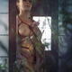 Beautiful woman with a rose standing at a window with Shibari bondage... (thumbnail)