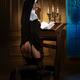 Naughty indecent nun with a seductive provocative look kneeling at pra... (thumbnail)