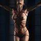Beautiful nude woman standing with red Shibari bondage ropes tied arou... (thumbnail)