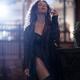 Beautiful seductive woman in black leather coat and sexy lingerie smok... (thumbnail)